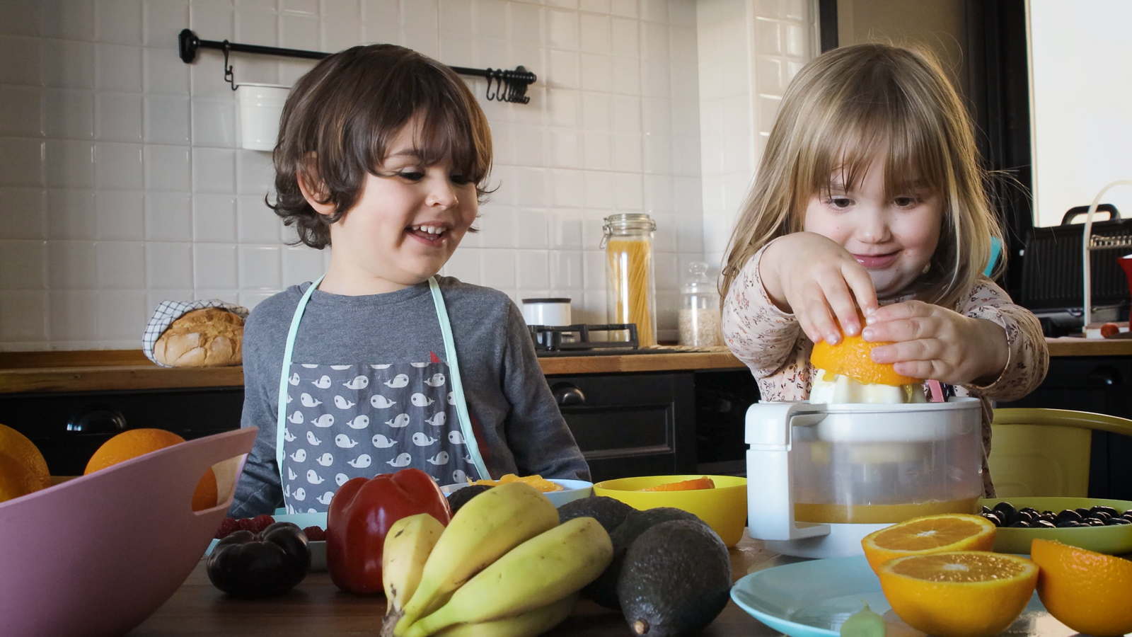 Children pressing oranges to make juice